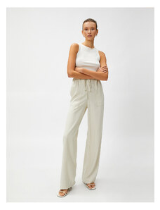 Koton Silky-textured, comfortable pants that are tied at the waist with pockets.